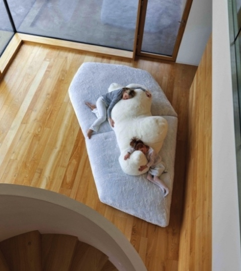 white polar bear sofa in a beautiful timber lounge