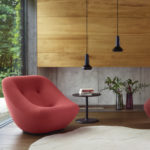 red sofa and armchair with two minimal black pendant lights
